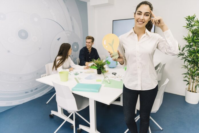 smiling-businesswoman-with-idea-concept-holding-paper-light-bulb