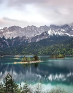 Emerald mountain lake with snowy peaks