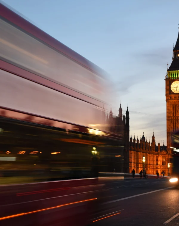 Red bus passing Big Ben in London
